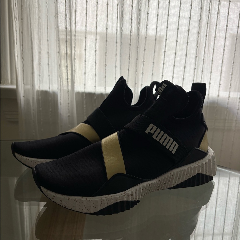 Puma women’s Black and Gold Athletic Sneakers